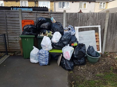 Cluttered garage before clearance service in Tring